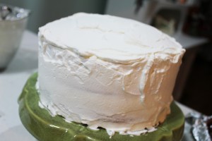 Cover the entire cake with whipping cream. At this point, I freeze the cake until I'm ready to serve. Even if you are making it the same day you want to serve, at least give it time to get thoroughly chilled in the fridge. Serving it cold is part of what makes it so good.