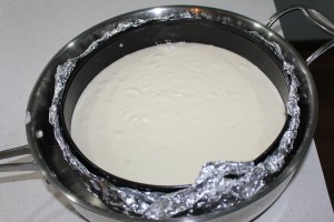 Pour water around outside edge of springform. Make sure you've wrapped the springform pan in foil to keep any water from leaking into your cheesecake batter.