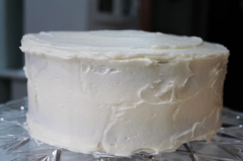 Frost the cake with Cream Cheese Frosting. If it starts getting crumbs in the frosting, give it a light  "base coat," freeze, then give it a nice thick covering with the frosting.