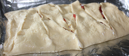 Fold up the crescent dough edges so they meet in the middle. Pinch edges to seal. 