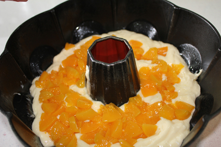 Pour half of the batter into greased bundt pan. Sprinkle in peaches. Top with remaining batter.