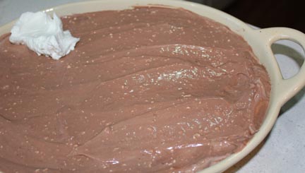 Spoon on top of pudding mixture already in the pan, then top with remaining whipping cream.