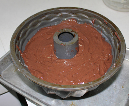 Spray a bundt pan with non-stick cooking spray. Spoon in half of the chocolate cake batter.