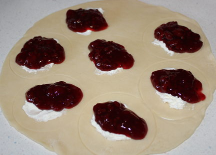 Add a heaping tablespoon of raspberry pie filling. Keep it away from the edges as best you can.
