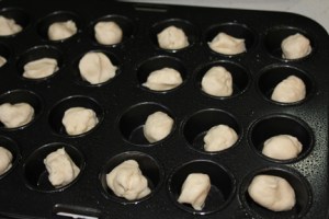 While the apples are cooking, you can start filling your mini-cupcake cups with the chilled dough. Shape dough into calls about the size of walnuts.