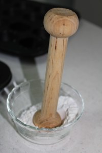 Use a tart tamper to press the dough into the cups.
