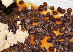 Cover chips with caramel topping and sprinkle on some sea salt. Crumble remaining crust over the top and bake at 350 degrees for bake for 15 minutes.