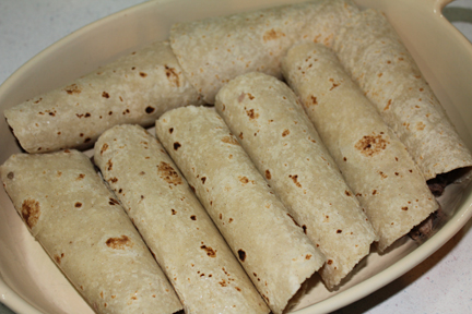Roll up the tortillas and place in a large baking dish.