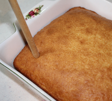 Using the handle of a wooden spoon, poke your cake full of holes (about an inch or so apart).