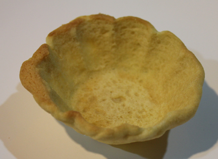 Bake in a 350 degree oven until lightly browned then cool. You can form a handle out of dough. Just roll a rope of dough and bend it in a handle shape and bake along with the cups.