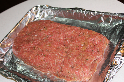 Form mixture into a loaf on a rimmed baking sheet. I lined mine with foil because I'm lazy and don't like scraping goo off the pan. The loaf should be about twelve inches long, four to five inches wide and at least an inch and a half to two inches deep. 