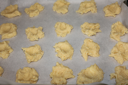 Drop dough on a cookie sheet, spacing them far enough apart they don't run into each other as they bake. (I lined my pan with parchment because I'm lazy and didn't want to scrape baked on jam off the pan.)
