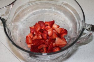 Wash berries, remove stems and hulls and place in a bowl. I cut mine into pieces and chunks.