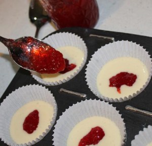 Drop about 1/2 teaspoon of jam into each cupcake center. If you don't have enough batter in the cup, the jam will sink to the bottom.