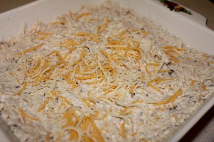 Then scoop into your baking pan. If you love cheese, go ahead and sprinkle some on top.