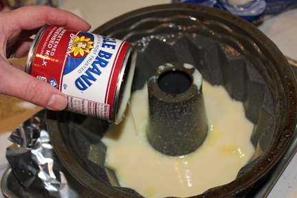Pour a can of sweetened condensed milk into a bundt pan that has been sprayed with non-stick cooking spray.